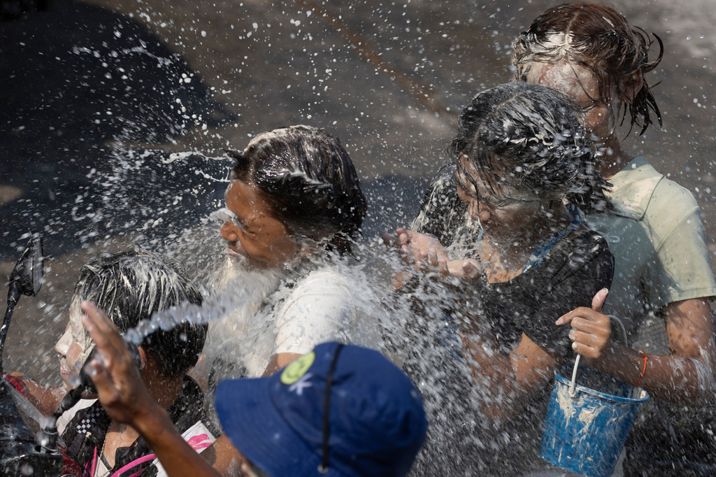 People participate in the Songkran water festival to celebrate the Thai New Year in Prachinburi province, Thailand, Monday, April 13, 2026. (AP Photo/Wason Wanichakorn)
