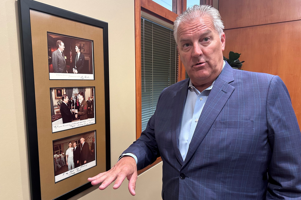 Republican candidate for Congress Kevin Hermening discusses meeting former presidents Ronald Reagan and Jimmy Carter shortly after his release from Iran in 1981 as shown on photos hanging on his office wall in Wausau, Wis., on Thursday, June 25, 2026. (AP Photo/Scott Bauer)