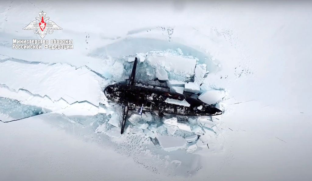 FILE - This photo taken from video released on March 26, 2021 by the Russian Defense Ministry press service shows a Russian nuclear submarine breaking through the Arctic ice during military drills at an unspecified location. (Russian Defense Ministry Press Service via AP, File)