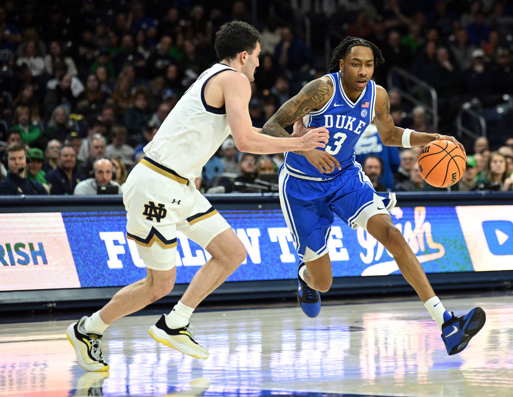 Duke guard Isaiah Evans (3) dribbles the ball down court against Notre Dame guard Logan Imes during the second half of an NCAA basketball game, Tuesday, Feb. 24, 2026, in South Bend, Ind. (AP Photo/Marc Lebryk)