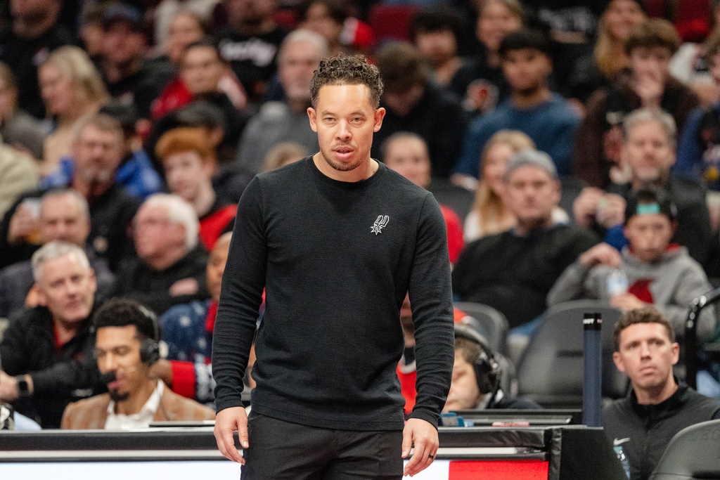 San Antonio Spurs head coach Mitch Johnson looks on from the sidelines during the second half of an Emirates NBA Cup basketball game against the Portland Trail Blazers, Wednesday, Nov. 26, 2025, in Portland, Ore. (AP Photo/Ali Gradischer)