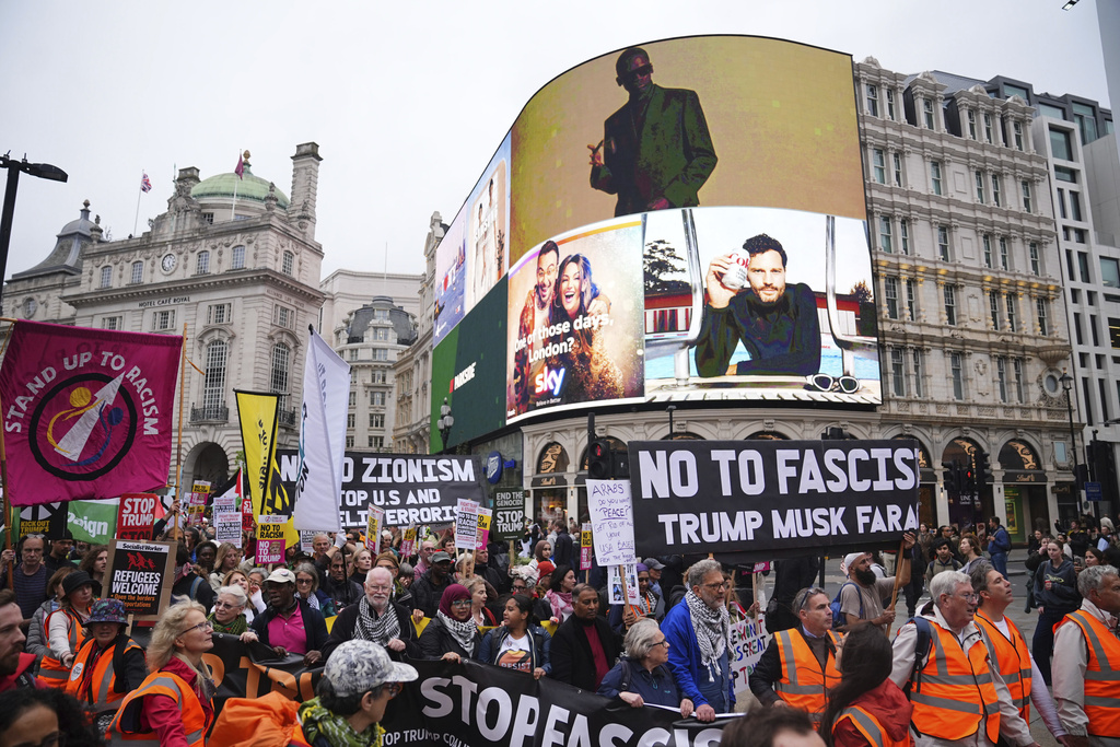 Campaigners hold signs and wave Palestinian flags during a Stop Trump Coalition protest march from Portland Place to Parliament Square in London, Wednesday Sept. 17, 2025. (James Manning/PA via AP)