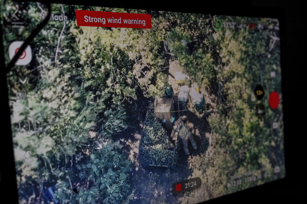 A screen shows Ukrainian servicemen unloading a land drone on the front line near Kostiantynivka, Ukraine, on Wednesday, Sept. 10, 2025. (AP Photo/Alex Babenko)