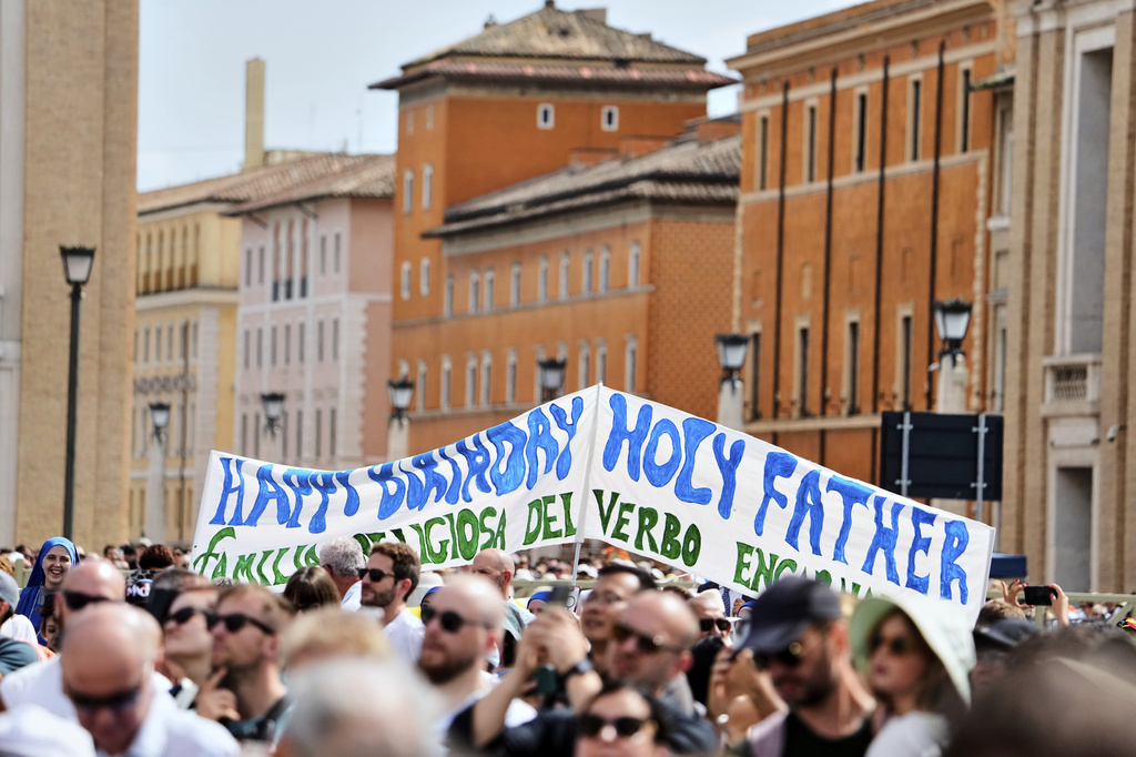 Faithful display a banner wishing happy 70th birthday to Pope Leo XIV as he appears at his studio's window to bless the faithful gathered in St. Peter's Square at the Vatican for the Angelus prayer, Sunday, Sept. 14, 2025. (AP Photo/Gregorio Borgia)