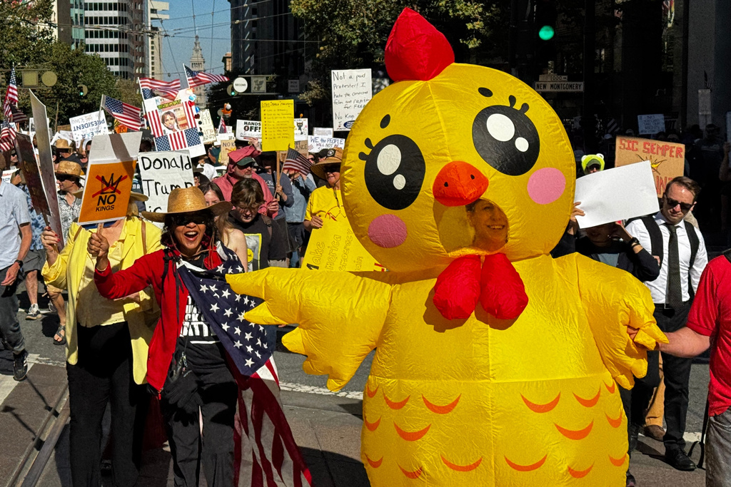 Protesters march through downtown San Francisco as part of the nationwide "No Kings" demonstrations on Saturday, Oct. 18, 2025. (AP Photo/Terry Chea)