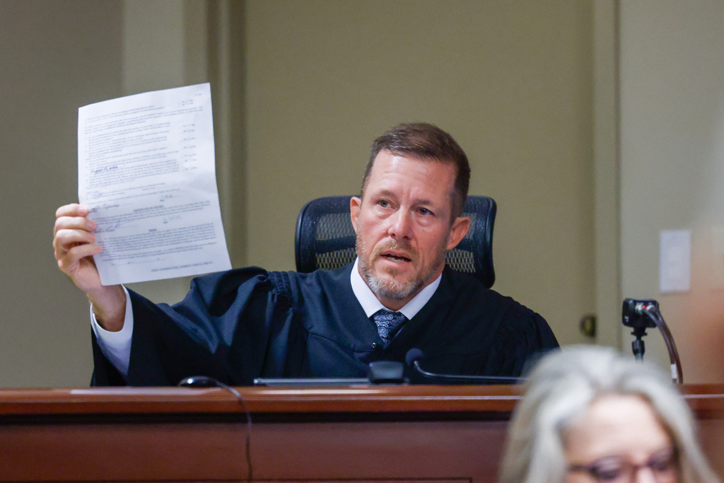 Judge Nicholas Primm holds a plea document for Colt Gray, the 16-year-old Apalachee High School shooting suspect, at Barrow County Superior Court in Winder, Ga., on Friday, July 24, 2026. (Arvin Temkar/Atlanta Journal-Constitution via AP)