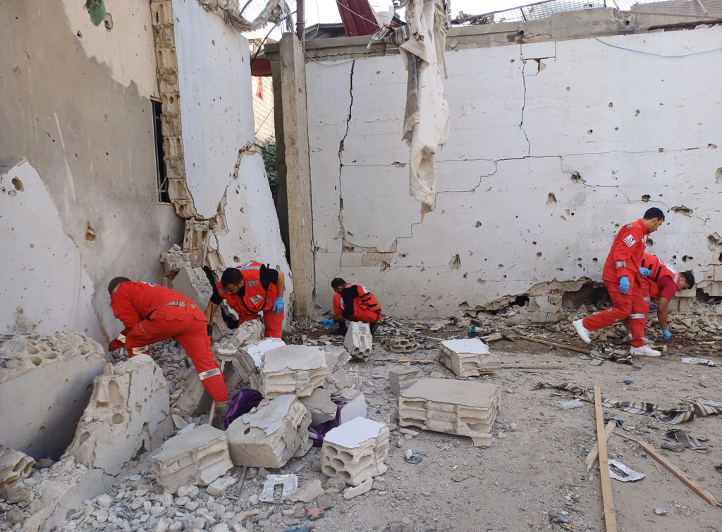 Palestinian rescue workers collect body remains at the scene where an Israeli strike on Tuesday night hit the Ein el-Hilweh Palestinian refugee camp, in the southern port city of Sidon, Lebanon, Wednesday, Nov. 19, 2025. (AP Photo/Mohammed Zaatari)