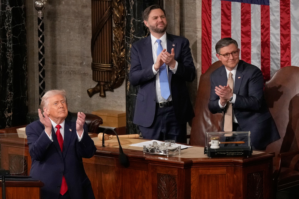 President Donald Trump delivers the State of the Union address to a joint session of Congress in the House chamber at the U.S. Capitol in Washington, Tuesday, Feb. 24, 2026, as Vice President JD Vance and House Speaker Mike Johnson of La., applaud. (AP Photo/Mark Schiefelbein)