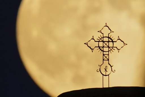 The Harvest Supermoon rises behind the cross of 'Metamorphosis Sotiros' Christian Orthodox Church at Anthoupolis outskirts of capital Nicosia, Cyprus, on Monday, Oct, 6, 2025. (AP Photo/Petros Karadjias) The Harvest Supermoon rises behind the cross of 'Metamorphosis Sotiros' Christian Orthodox Church at Anthoupolis outskirts of capital Nicosia, Cyprus, on Monday, Oct, 6, 2025. (AP Photo/Petros Karadjias)