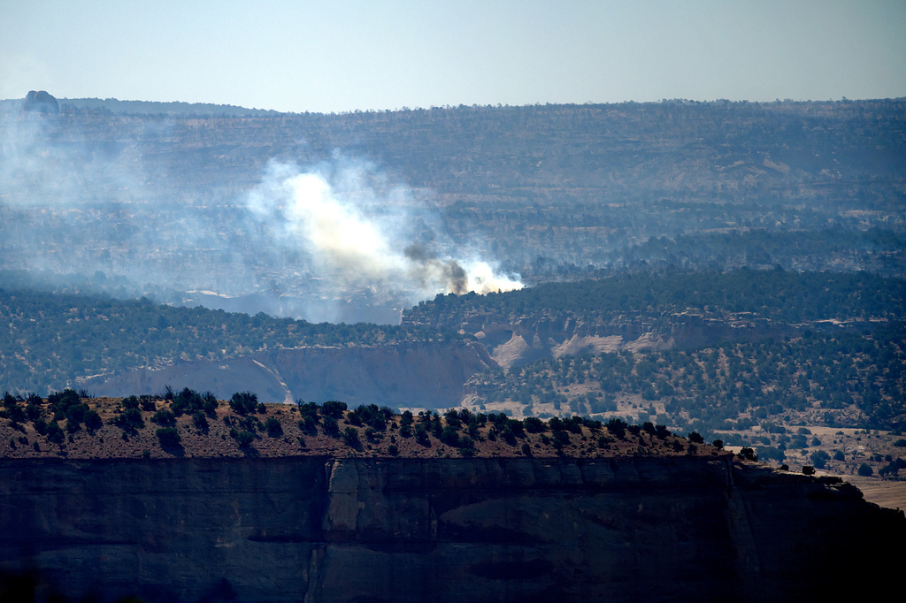 Smoke rises from the Snyder Fire burning near Thompson Springs, Utah, on Sunday, June 28, 2026. (AP Photo/Noah Berger)