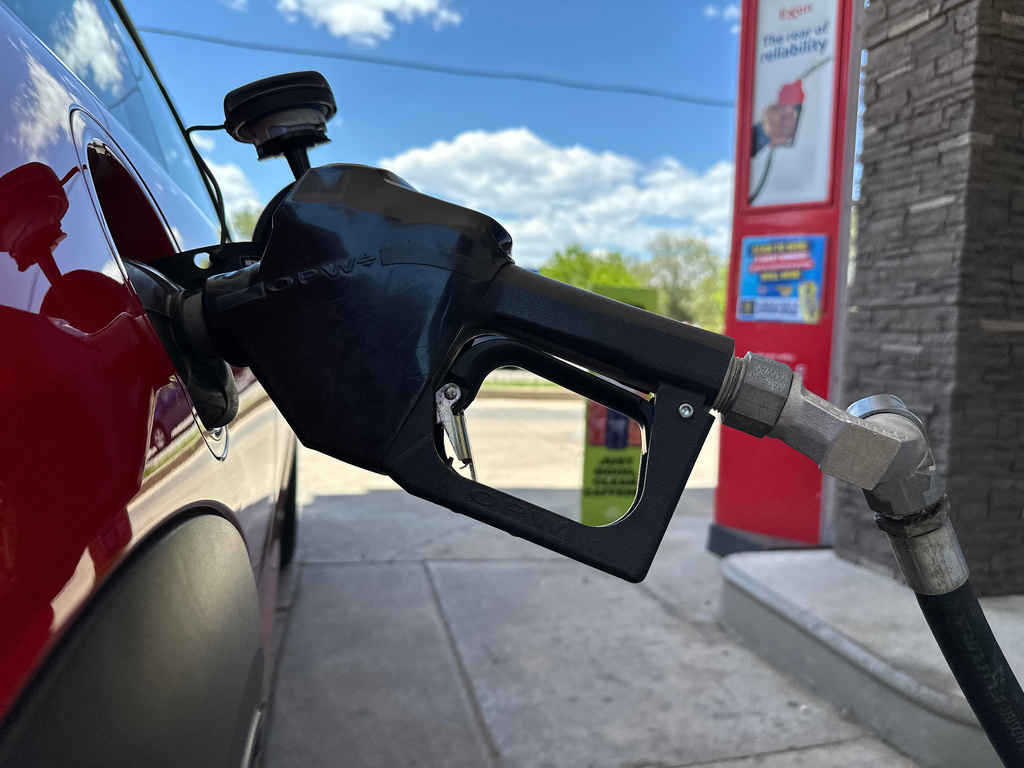 A pump fills up the tank of a vehicle at an Exxon gasoline station in Litttleton, Colo., Tuesday, May 12, 2026. (AP Photo/David Zalubowski)