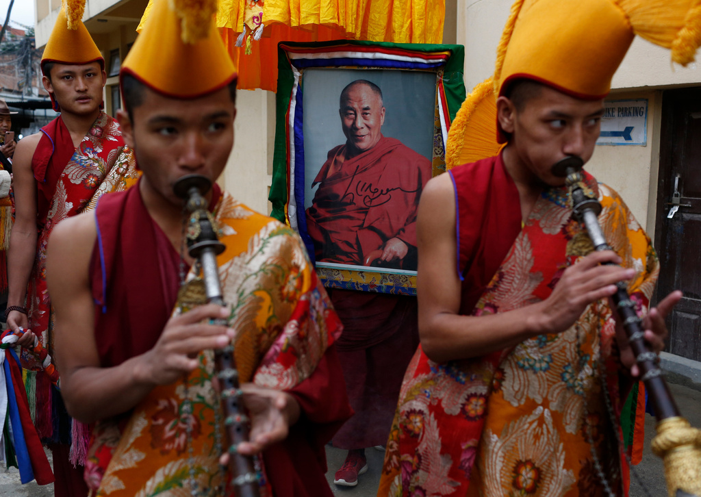 FILE -Exile Tibetan Buddhist monks carry a portrait of Tibetan spiritual leader the Dalai Lama as they gather to celebrate Losar, or Tibetan New Year, celebrations in Kathmandu, Nepal, Wednesday, Feb. 26, 2020. (AP Photo/Niranjan Shrestha, File)