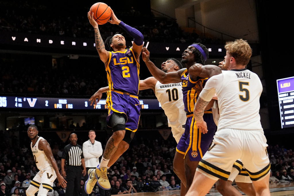 LSU guard Jalen Reece (2) shoots the ball past Vanderbilt forward Ak Okereke (10) during the first half of an NCAA college basketball game Saturday, Jan. 10, 2026, in Nashville, Tenn. (AP Photo/George Walker IV)