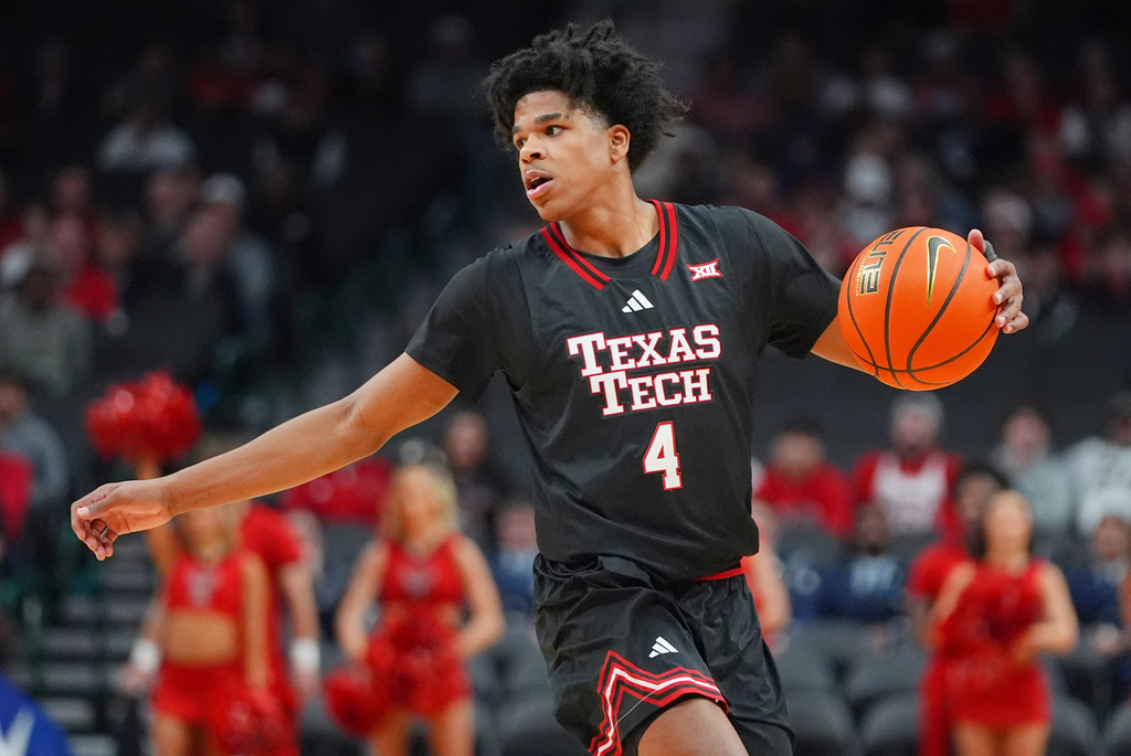 Texas Tech guard Christian Anderson dribbles during the first half of an NCAA college basketball game against Arkansas, Saturday, Dec. 13, 2025, in Dallas. (AP Photo/LM Otero)