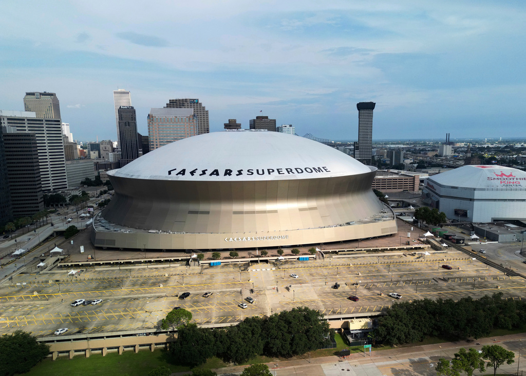 FILE - An aerial overall exterior general view of Caesars Superdome and the Smoothie King Center with the New Orleans skyline in the background is seen after an NFL preseason football game between the New Orleans Saints and the Denver Broncos in New Orleans, Saturday, Aug. 23, 2024. (AP Photo/Tyler Kaufman, file)