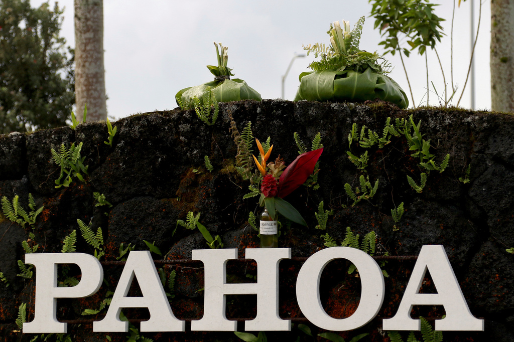 FILE - A sign welcomes people to Pahoa, Hawaii, on May 15, 2018. (AP Photo/Caleb Jones, File)