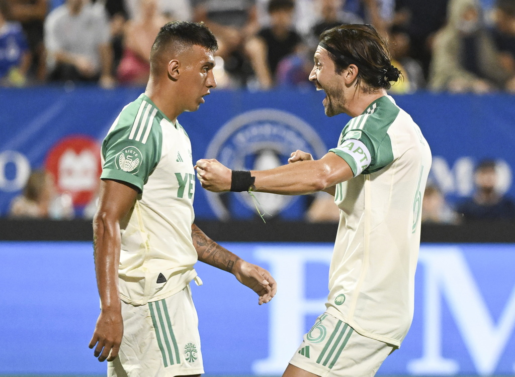 Austin FC's Myrto Uzuni, left, celebrates after his goal against CF Montreal with teammate Ilie Sanchez (6) during first-half MLS soccer match action in Montreal, Saturday, Aug. 23, 2025. (Graham Hughes/The Canadian Press via AP)