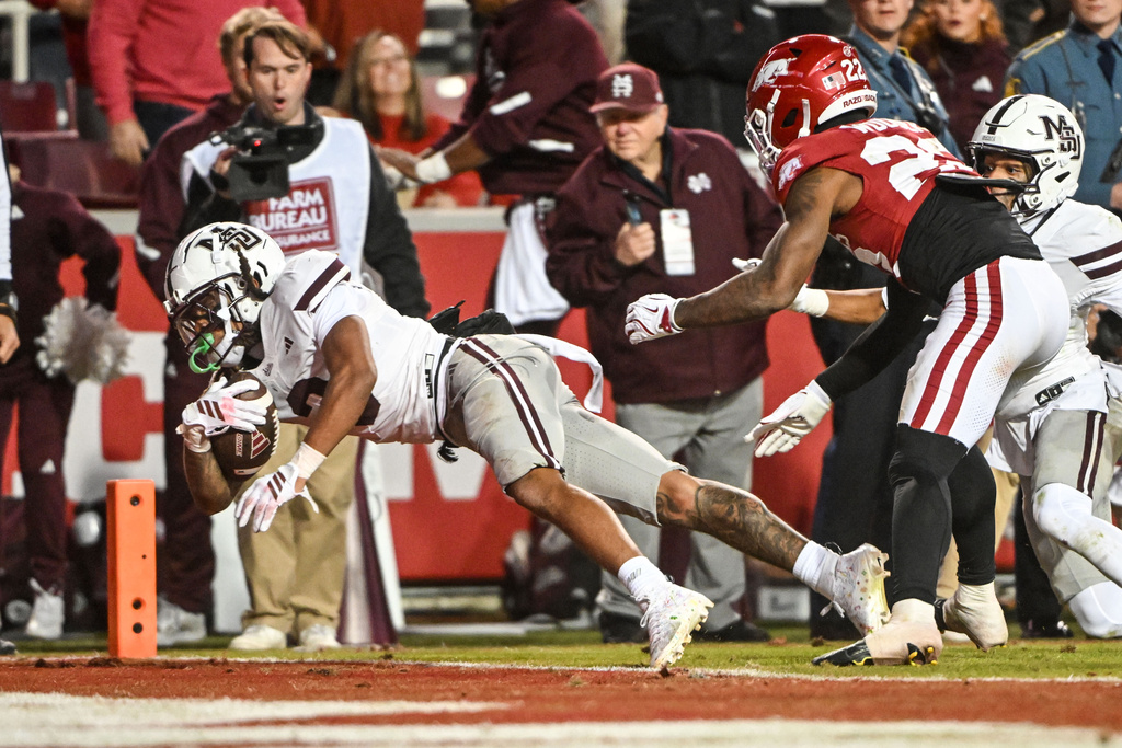 Mississippi State wide receiver Anthony Evans III (3) dives into the end zone to score a touchdown to take the lead over Arkansas in the final seconds of the second half of an NCAA college football game Saturday, Nov. 1, 2025, in Fayetteville, Ark. (AP Photo/Michael Woods)