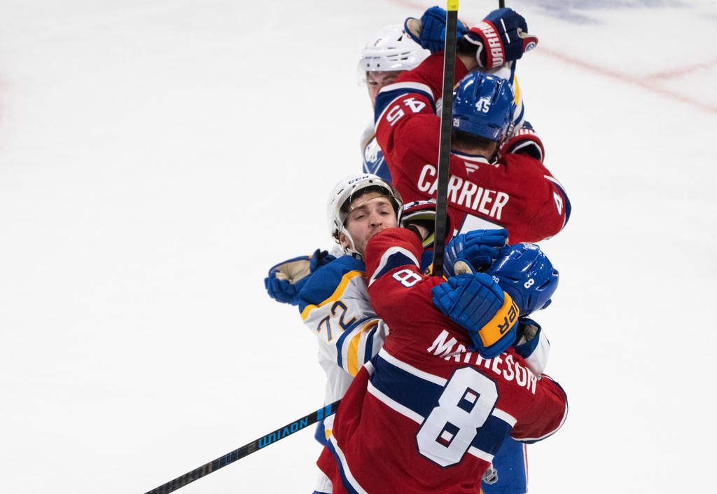 Montreal Canadiens' Mike Matheson (8) and Alexandre Carrier (45) rough it up with Buffalo Sabres' Tage Thompson (72) and Zach Benson, top, during the third period of Game 6 in a second-round NHL hockey Stanley Cup playoff series in Montreal, Saturday, May 16, 2026. (Christinne Muschi/The Canadian Press via AP)