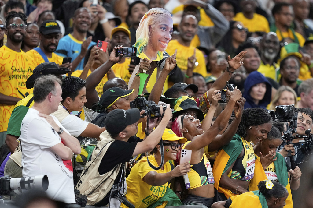 Jamaica's Shelly-Ann Fraser-Pryce and her teammates celebrate with supporters after taking the silver in the women's 4 X 100 meters relay final at the World Athletics Championships in Tokyo, Sunday, Sept. 21, 2025. (AP Photo/Petr David Josek)