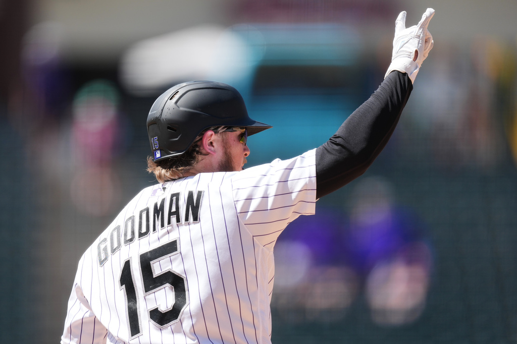 Colorado Rockies' Hunter Goodman gestures to the bullpen as he circles the bases after hitting a two-run home run off Cincinnati Reds starting pitcher Hunter Greene in the sixth inning of a baseball game Sunday, July 19, 2026, in Denver. (AP Photo/David Zalubowski)