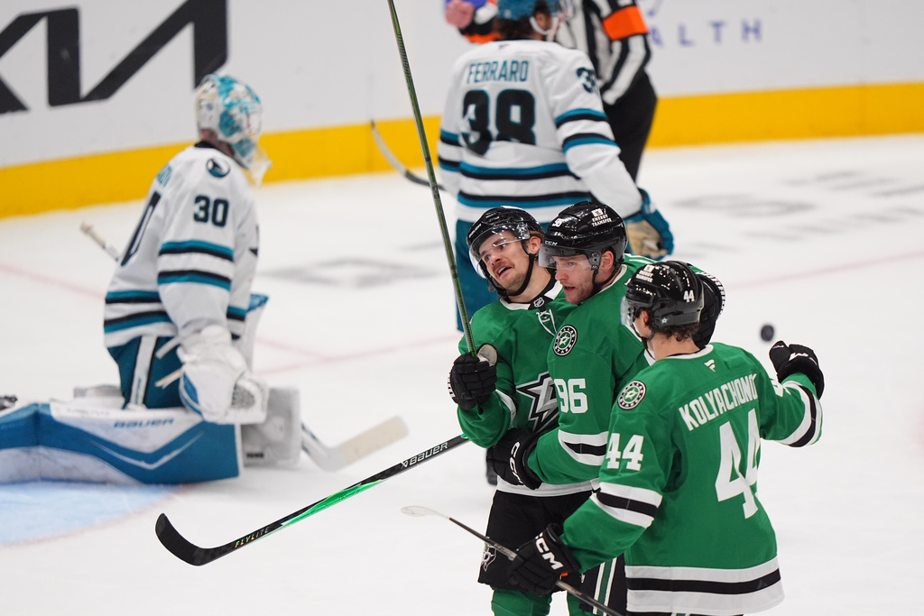 Dallas Stars right wing Mikko Rantanen (96) celebrates his goal with teammates Vladislav Kolyachonok (44) and Sam Steel (18) as San Jose Sharks goaltender Yaroslav Askarov (30) sits nearby during the third period of an NHL hockey game Friday, Dec. 5, 2025, in Dallas. (AP Photo/LM Otero)