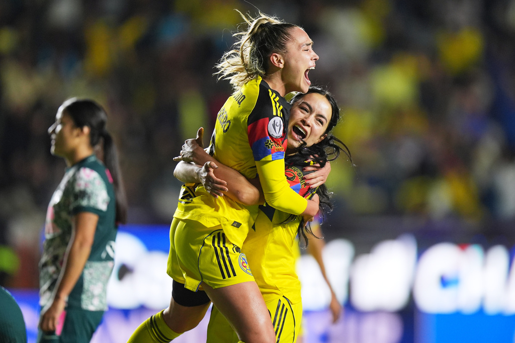 Irene Guerrero of Mexico's America, top, is congratulated after scoring her side's 4th goal against The United States' Washington Spirit during the Women's CONCACAF Champions Cup final soccer match in Pachuca, Mexico, Saturday, May 23, 2026.(AP Photo/Fernando Llano)