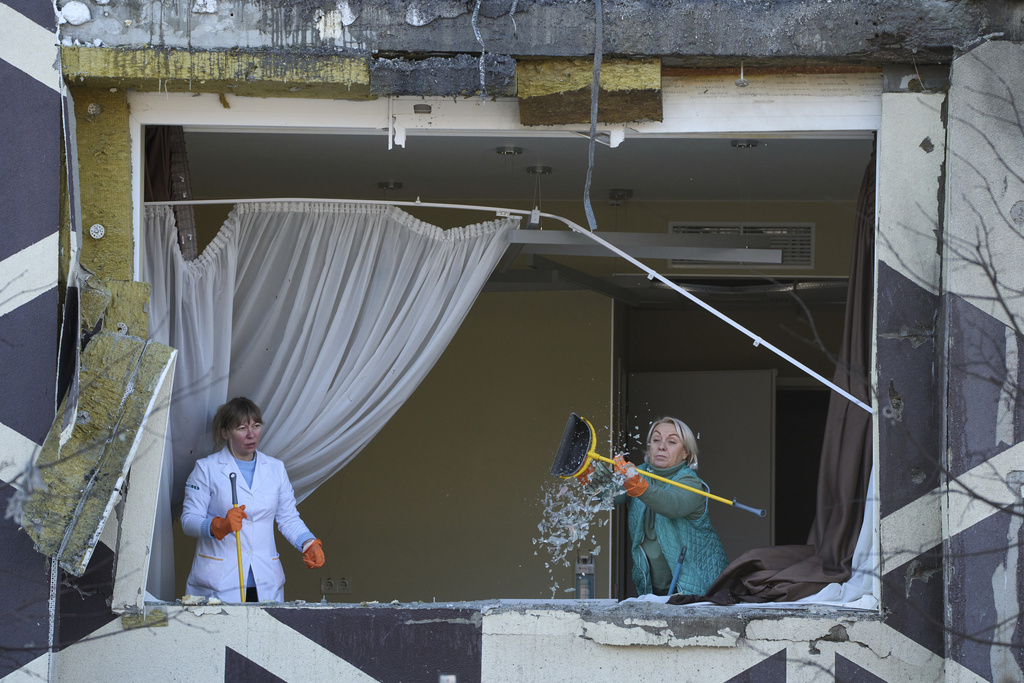 Medical workers remove the debris in a damaged private clinic after, according to Ukrainian officials, a Russian drone hit a hospital room killing a patient, in Kyiv, Ukraine, Monday, Jan 5, 2026. (AP Photo/Efrem Lukatsky)