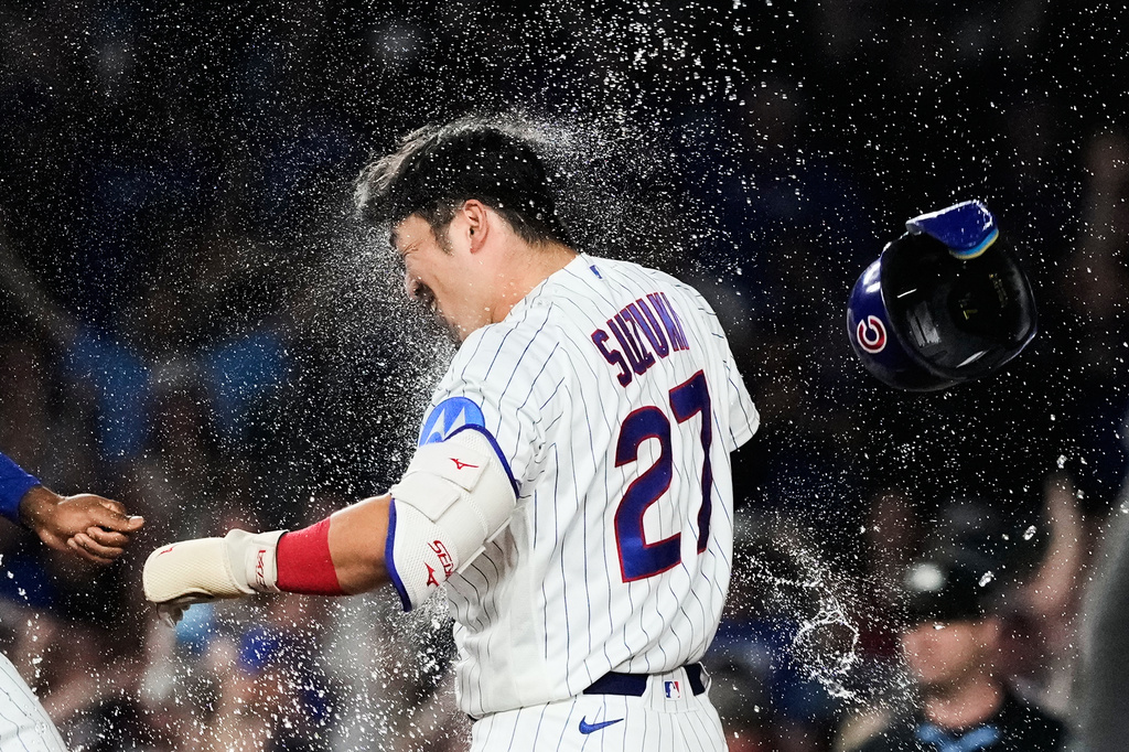 Chicago Cubs' Seiya Suzuki of Japan, celebrates with a teammate after hitting a walk-off one-run single during the ninth inning of a baseball game against the San Diego Padres in Chicago, Monday, June 29, 2026. (AP Photo/Nam Y. Huh)