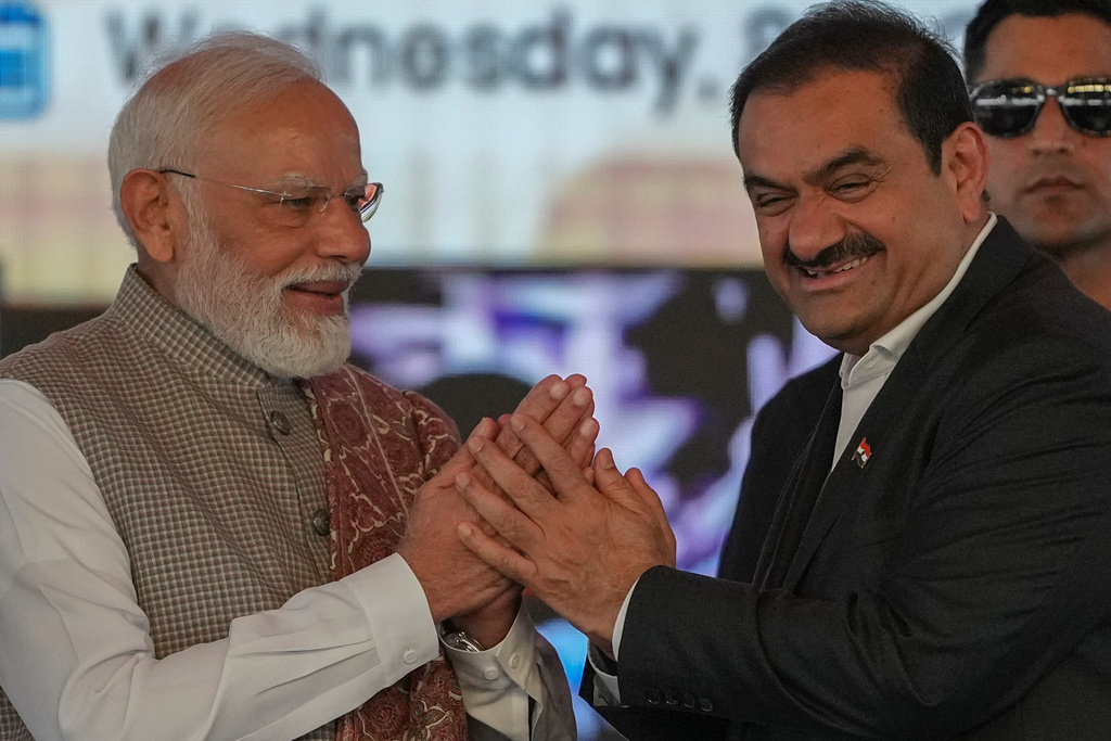 Indian Prime Minister Narendra Modi, left, greets Chairman Adani Group, Gautam Adani during the inauguration ceremony of the Navi Mumbai International Airport in Navi Mumbai, India, Wednesday, Oct. 8, 2025. (AP Photo/Rafiq Maqbool)