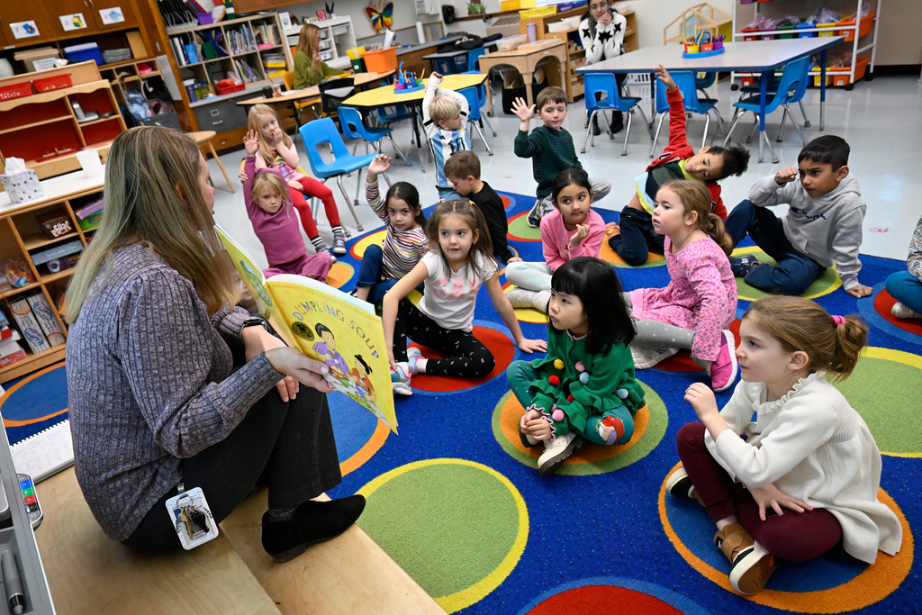 Kindergarten teacher Christin Labriola reads the book "Dumpling Soup" to her class, incorporating Asian American and Pacific Islander subjects in her class at Webster Hill Elementary School in West Hartford, Conn., on Dec. 2, 2025. (AP Photo/Jessica Hill)