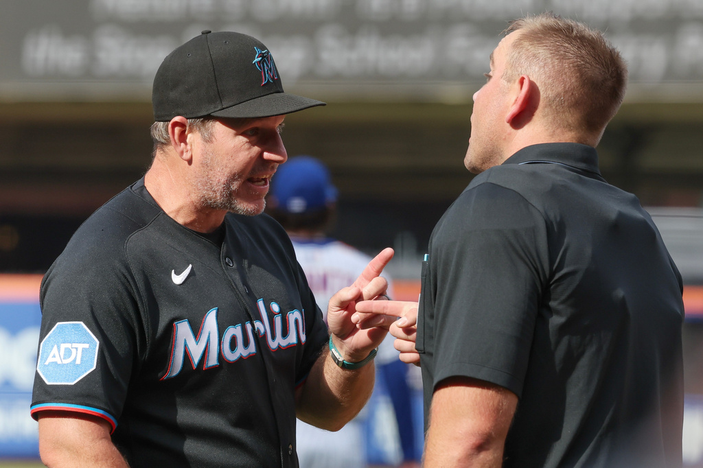Miami Marlins manager Clayton McCullough, left, argues with home plate umpire Brock Ballou, right, during the second inning of a baseball game against the New York Mets, Saturday, Aug. 1, 2026, in New York. (AP Photo/Heather Khalifa)