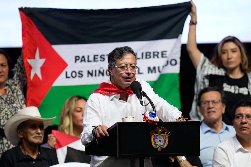 Supporters of Colombian President Gustavo Petro display a Palestinian flag as he addresses a rally in Ibague, Colombia, Friday, Oct. 3, 2025. (AP Photo/ Fernando Vergara)
