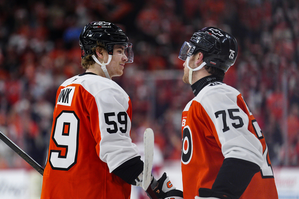 Philadelphia Flyers' Oliver Bonk, left, celebrates after scoring with Hunter McDonald during the first period of an NHL hockey game against the Montréal Canadiens, Tuesday, April 14, 2026, in Philadelphia. (AP Photo/Derik Hamilton)