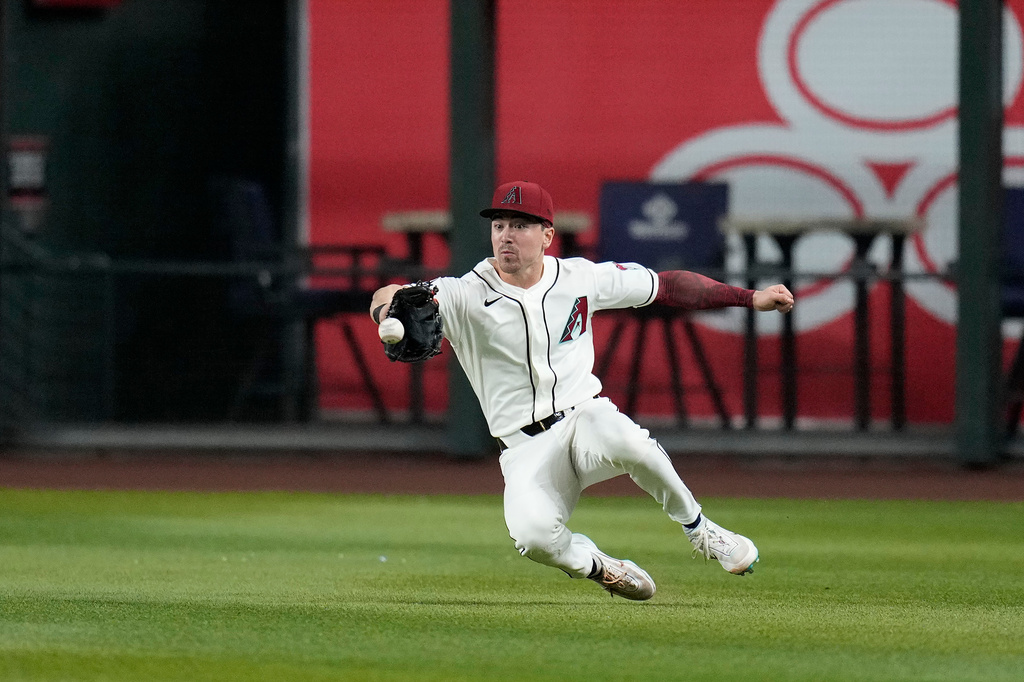 Arizona Diamondbacks right fielder Corbin Carroll makes a diving catch on a line drive hit by Chicago Cubs' Pedro Ramírez during the second inning of a baseball game, Tuesday, Aug. 25, 2026, in Phoenix. (AP Photo/Ross D. Franklin)
