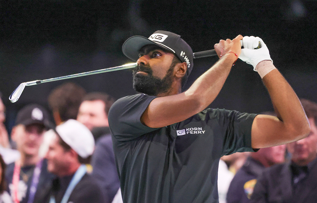 Sahith Theegala hits a practice iron before the TGL finals golf tournament in Palm Beach Gardens, Fla., Tuesday, March 24, 2026. (AP Photo/Reinhold Matay)