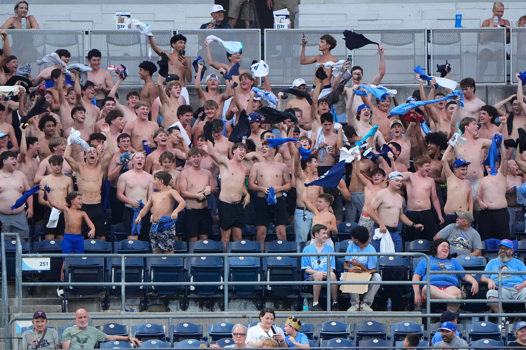 Fans cheer during the fifth inning of a baseball game between the Kansas City Royals and the Minnesota Twins, Wednesday, Aug. 5, 2026, in Kansas City, Mo. (AP Photo/Charlie Riedel)