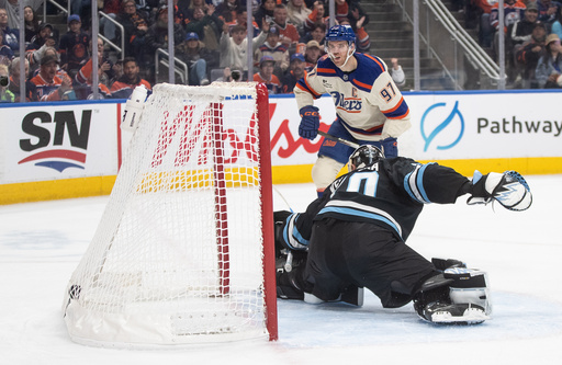 Utah Mammoth's goalie Karel Vejmelka (70) is scored on by Edmonton Oilers' Connor McDavid (97) during second period NHL action, in Edmonton on Tuesday, Oct. 28, 2025. (Jason Franson/The Canadian Press via AP) Utah Mammoth's goalie Karel Vejmelka (70) is scored on by Edmonton Oilers' Connor McDavid (97) during second period NHL action, in Edmonton on Tuesday, Oct. 28, 2025. (Jason Franson/The Canadian Press via AP)
