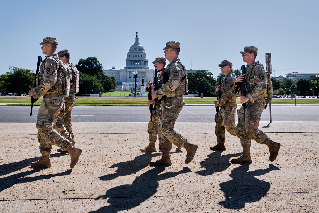 Armed National Guard soldiers from West Virginia patrol the Mall near the Capitol in Washington, as part of President Donald Trump's order to impose federal law enforcement in the nation's capital, Tuesday, Aug. 26, 2025. (AP Photo/J. Scott Applewhite)