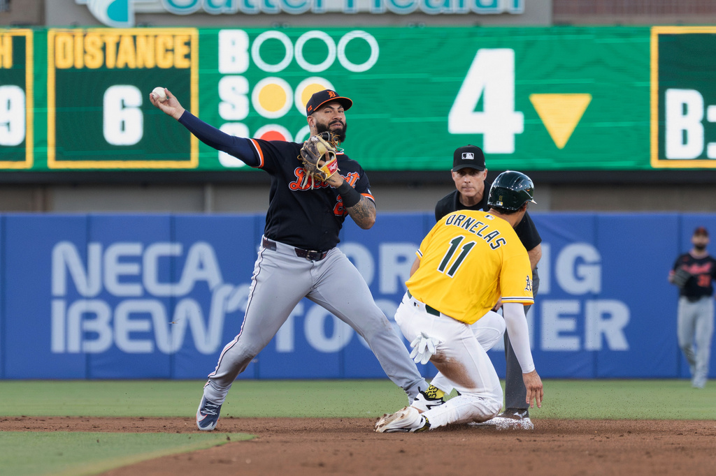 Detroit Tigers second baseman Gleyber Torres, left, attempts to turn a double play after getting Athletics' Jonathan Ornelas (11) out during the fourth inning of a baseball game Saturday, Aug. 1, 2026, in West Sacramento, Calif. (AP Photo/Sara Nevis)