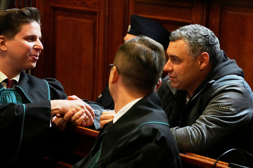 CAPTION CORRECTS THE SPELLING - Ukrainian defendant Volodymyr Zhuravlov, right, shakes hands with his lawyer Tymoteusz Paprocki, left, as a judge announce the decision not to allow for extradition to Germany in courtroom of Warsaw's Regional Court in Warsaw, Poland, Friday, Oct. 17, 2025. (AP Photo/Czarek Sokolowski) CAPTION CORRECTS THE SPELLING - Ukrainian defendant Volodymyr Zhuravlov, right, shakes hands with his lawyer Tymoteusz Paprocki, left, as a judge announce the decision not to allow for extradition to Germany in courtroom of Warsaw's Regional Court in Warsaw, Poland, Friday, Oct. 17, 2025. (AP Photo/Czarek Sokolowski)