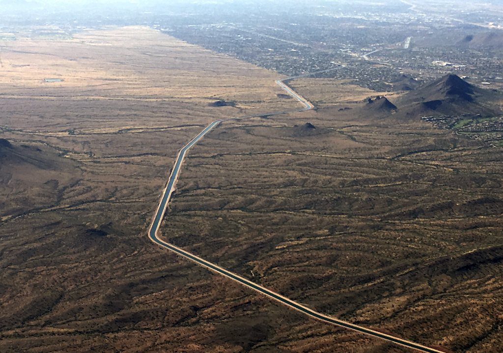 FILE - The Central Arizona Project canal runs through rural desert near Phoenix, Oct. 8, 2019. (AP Photo/Ross D. Franklin, File)