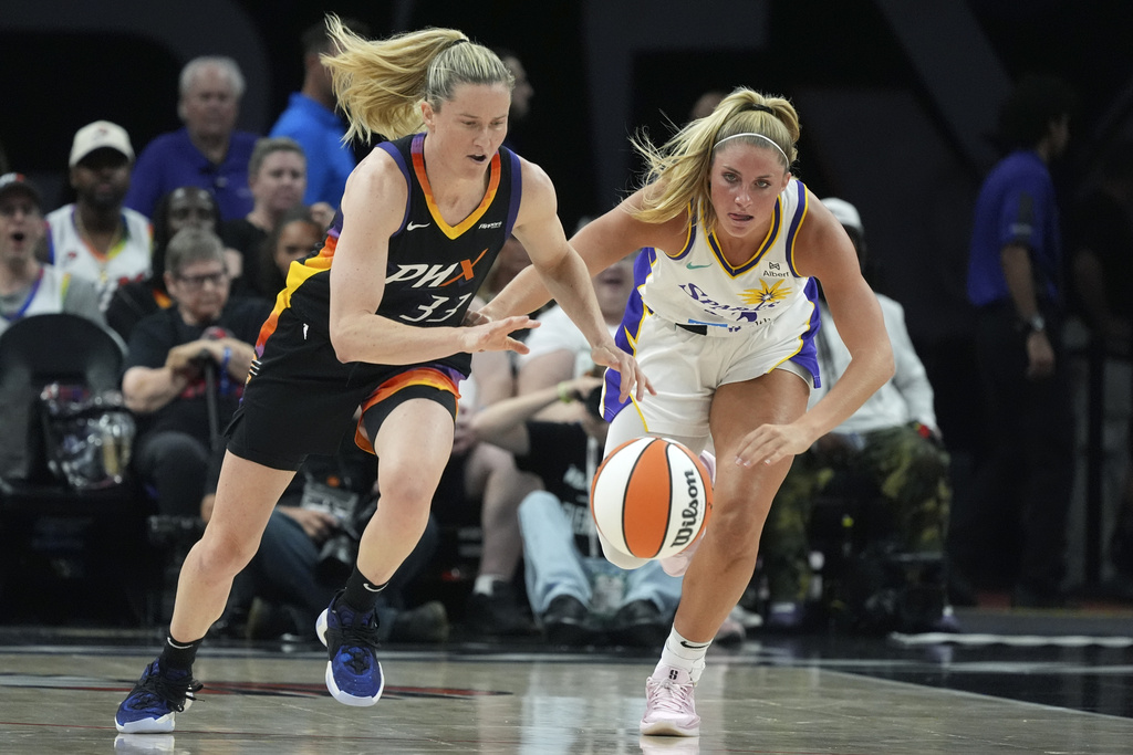 Phoenix Mercury guard Sami Whitcomb (33) steals the ball from Los Angeles Sparks guard Sarah Ashlee Barker during the first half of a WNBA basketball game Tuesday, Sept. 9, 2025, in Phoenix. (AP Photo/=01350812=)