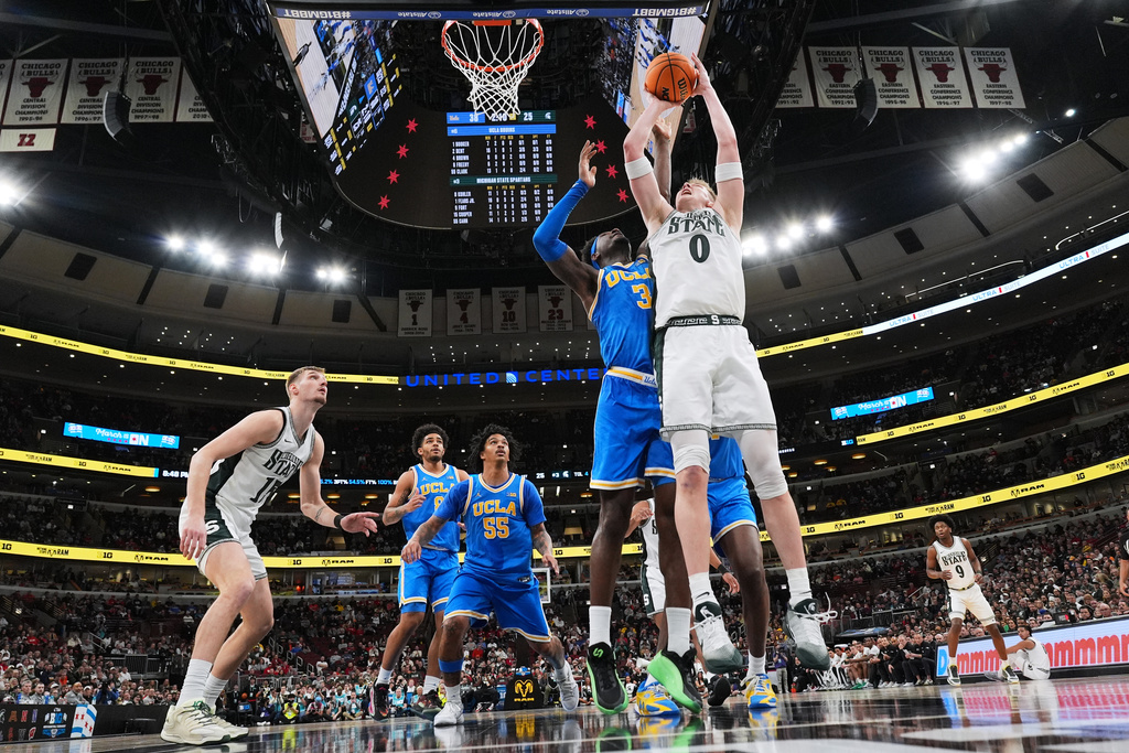 Michigan State forward Jaxon Kohler, right, goes up to shoot against UCLA forward Eric Dailey Jr. (3) during the first half of an NCAA college basketball game in the quarterfinals of the Big 10 Conference tournament, Friday, March 13, 2026, in Chicago. (AP Photo/Nam Y. Huh)