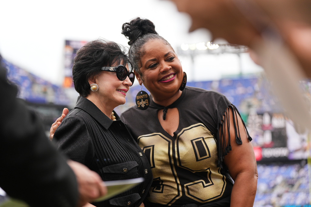 New Orleans Saints owner Gayle Bensons, left, greets people before an NFL football game against the Baltimore Ravens in Baltimore, Sunday, Sept. 20, 2026. (AP Photo/Stephanie Scarbrough)