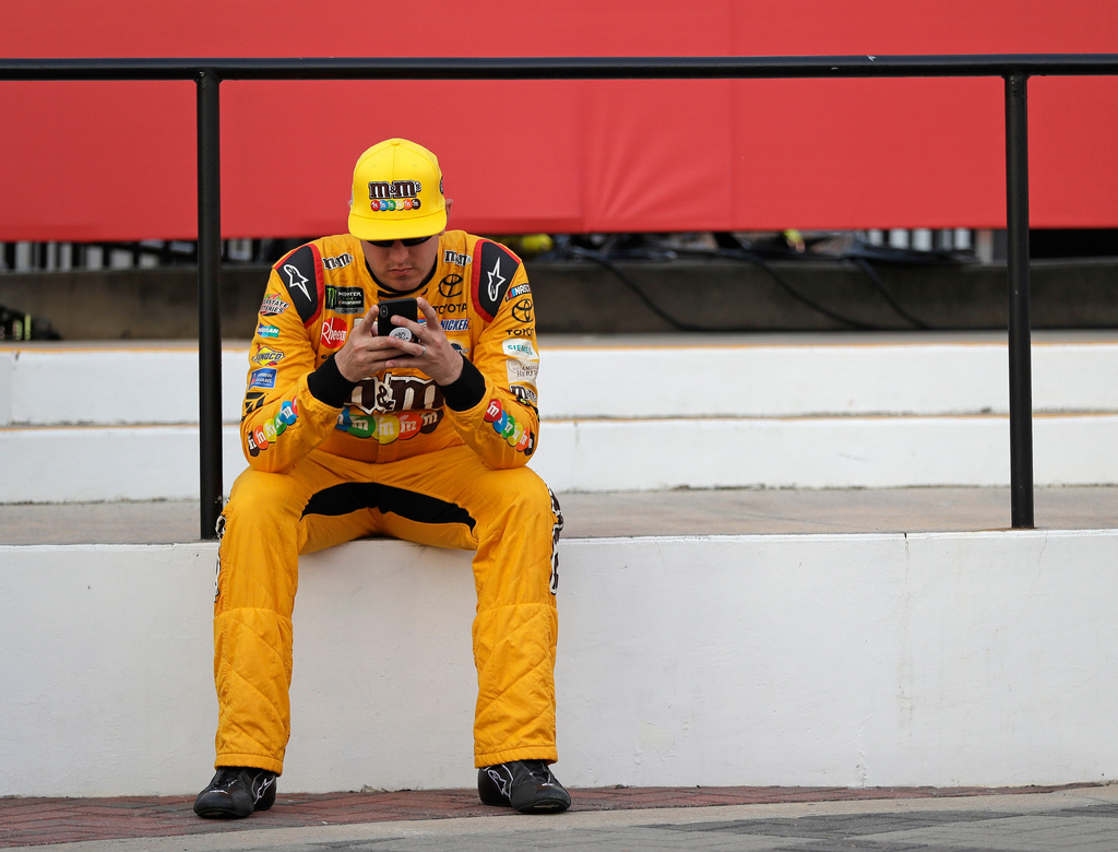 FILE - Kyle Busch waits in Victory Lane after winning the pole position for the NASCAR Cup series auto race at Charlotte Motor Speedway in Charlotte, N.C., Thursday, May 24, 2018. (AP Photo/Chuck Burton, File)