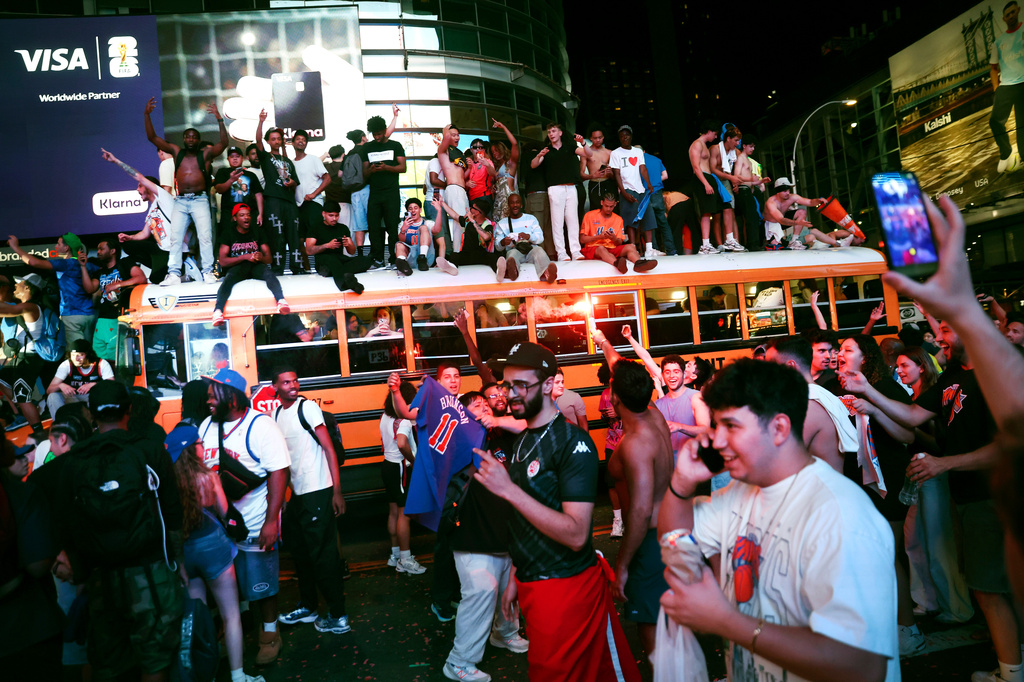 New York Knicks fans celebrate their victory after Game 5 of the NBA Finals basketball series against the San Antonio Spurs, Saturday, June 13, 2026, in New York. (AP Photo/Heather Khalifa)