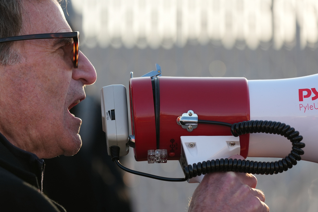 A demonstrator protests outside an ICE processing facility in the Chicago suburb of Broadview, Ill., Friday, Nov. 14, 2025. (AP Photo/Nam Y. Huh)