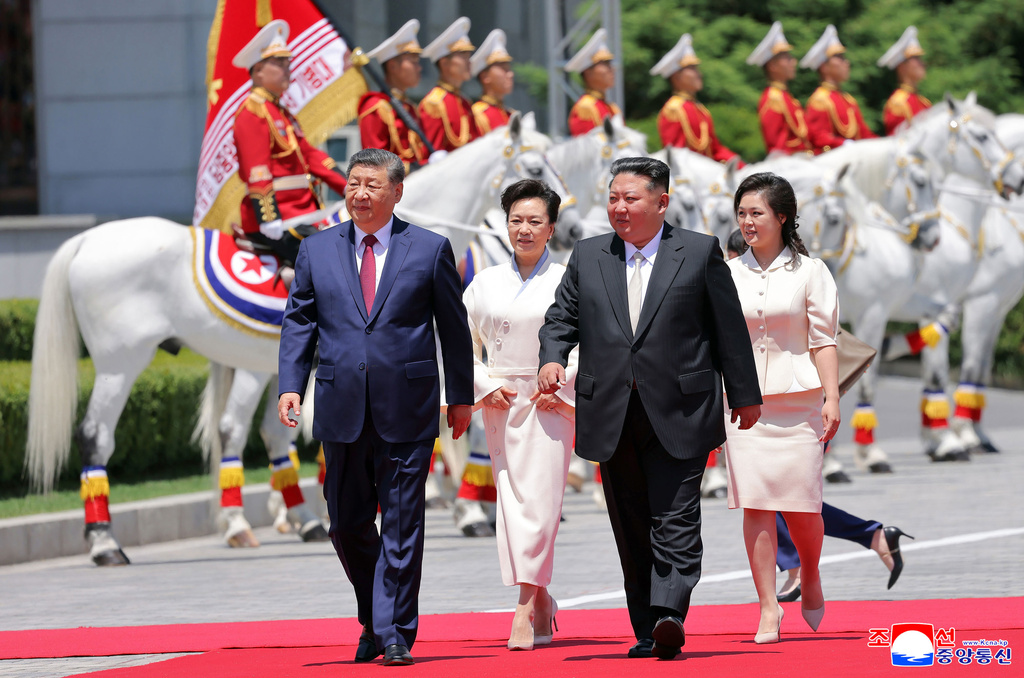 In this photo provided by the North Korean government, Chinese President Xi Jinping, left, and his wife Peng Liyuan, second left, accompanied by North Korean leader Kim Jong Un, second right, and his wife his wife Ri Sol Ju, attend a welcome ceremony in Pyongyang, Monday, June 8, 2026. Independent journalists were not given access to cover the event depicted in this image distributed by the North Korean government. The content of this image is as provided and cannot be independently verified. Korean language watermark on image as provided by source reads: "KCNA" which is the abbreviation for Korean Central News Agency. (Korean Central News Agency/Korea News Service via AP)