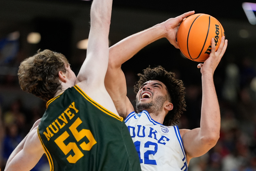 FILE - Duke forward Cameron Boozer shoots over Siena center Riley Mulvey during the second half in the first round of the NCAA college basketball tournament, March 19, 2026, in Greenville, S.C. (AP Photo/Chris Carlson, File)